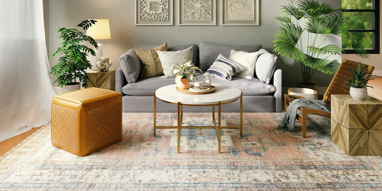 A living room with a grey sofa, round coffee table and a layered rug in soft colours