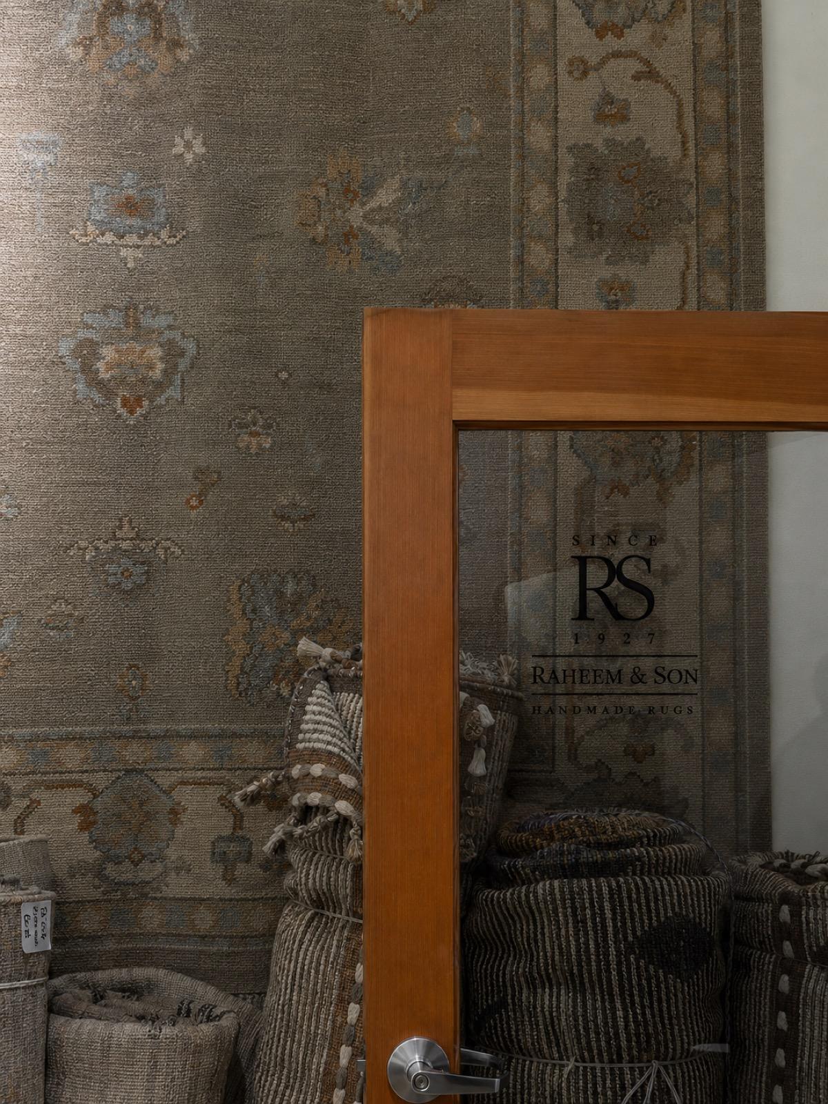 Raheem and Son branded showroom entrance with rolled rugs, Bhadohi