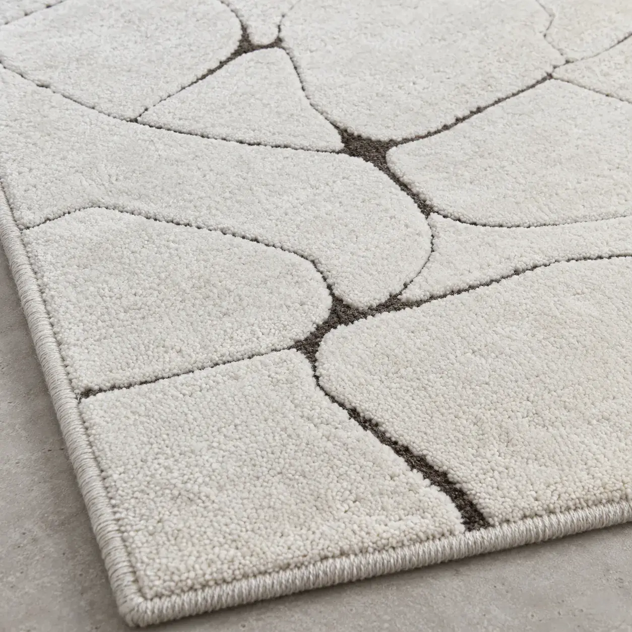 Close view of the Basil Rug in ivory brown showing its texture and detail