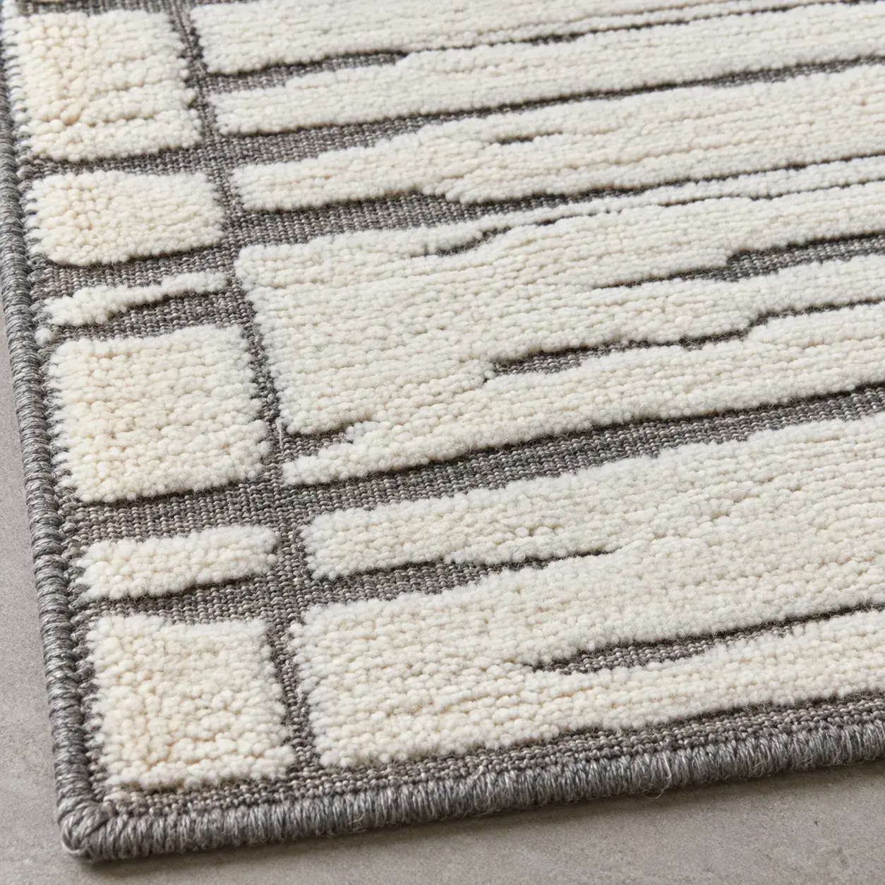 Close view of the Dalia Rug in grey ivory showing its texture and detail