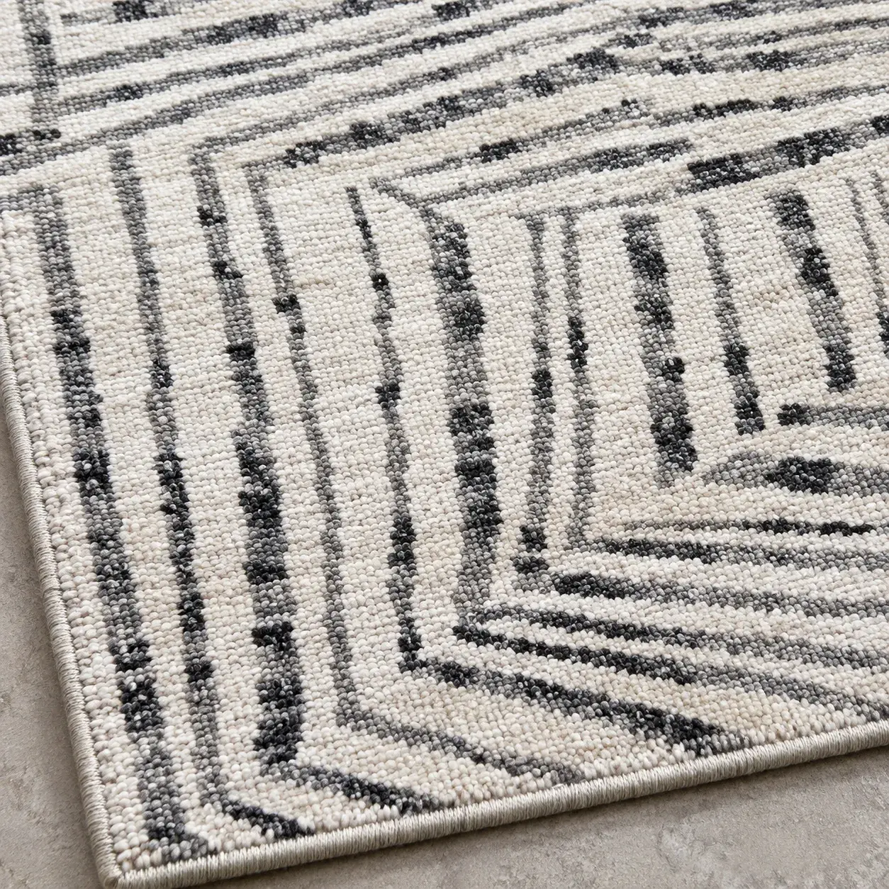 Close view of the Elowen Rug in ivory charcoal showing its texture and detail