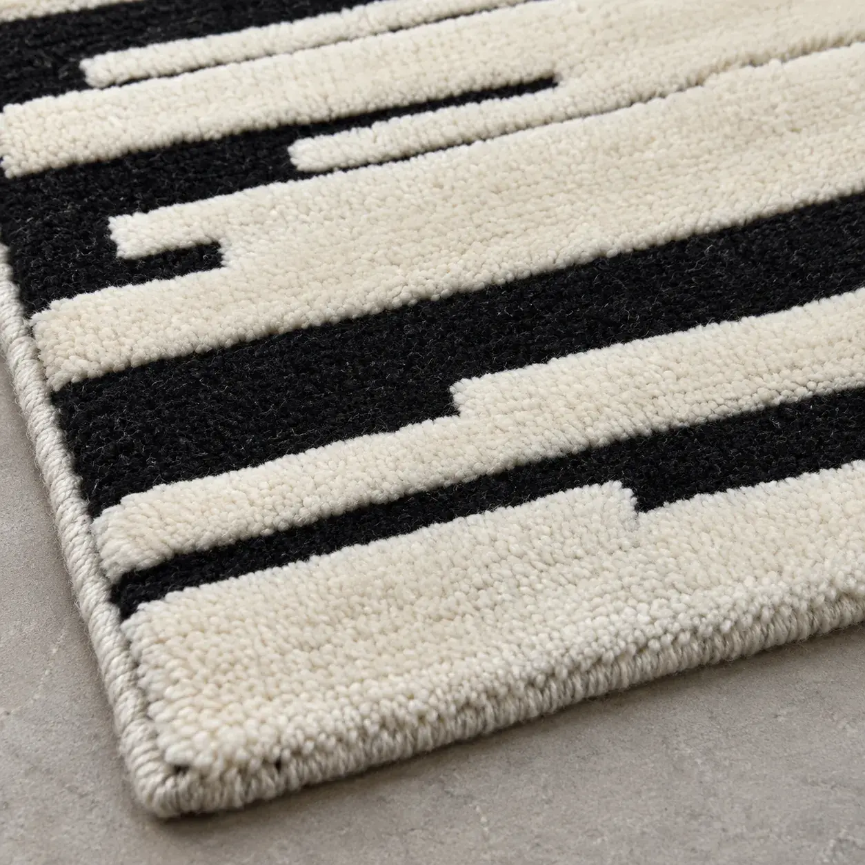 Close view of the Lagoon Rug in black ivory showing its texture and detail