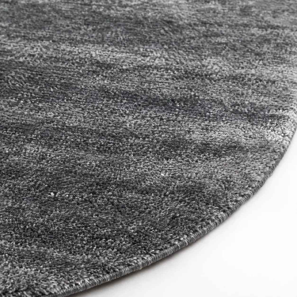 Close view of the Lucan Round Rug in light grey showing its texture and detail