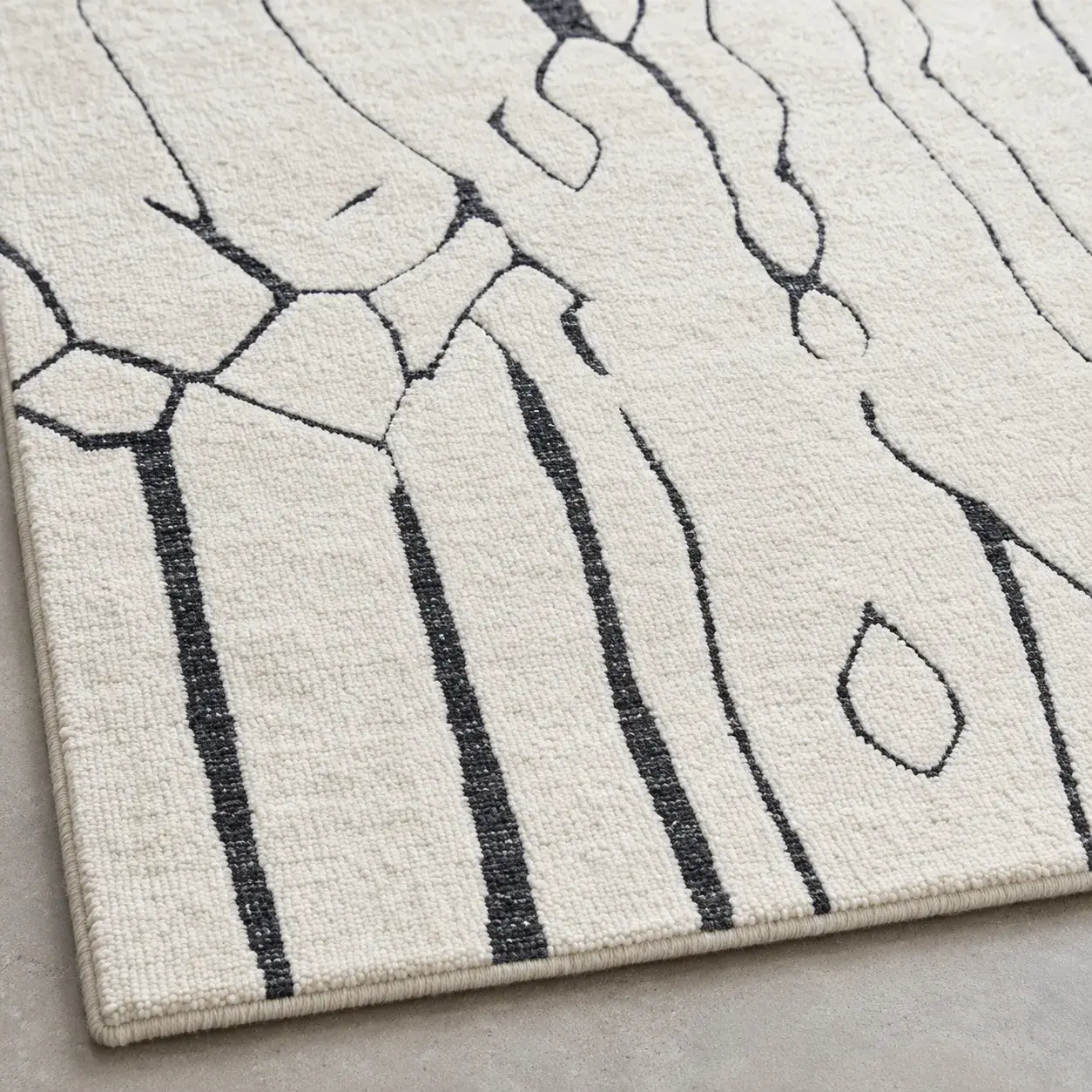 Close view of the Perrin Rug in ivory black showing its texture and detail