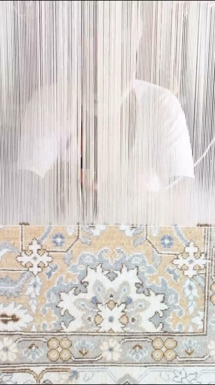A hand-knotted rug on the loom in the Raheem & Son weaving hall