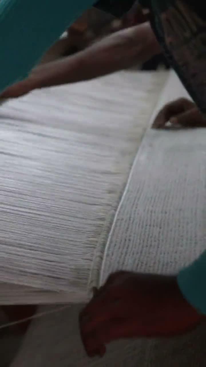 A weaver laying warp threads for an RS Contract commission