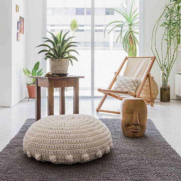 Handcrafted wool and jute pouf in a living room setting
